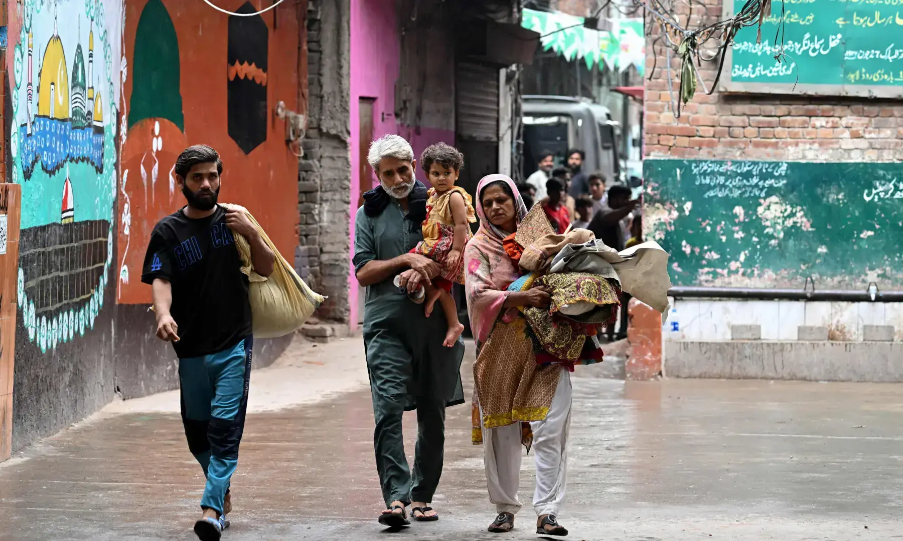  Evacuated residents arrive from their submerged homes, to take shelter at a government school after floodwaters entered from the overflowing Ravi river in Shahdara, Lahore on August 29, 2025. &mdash; AFP 