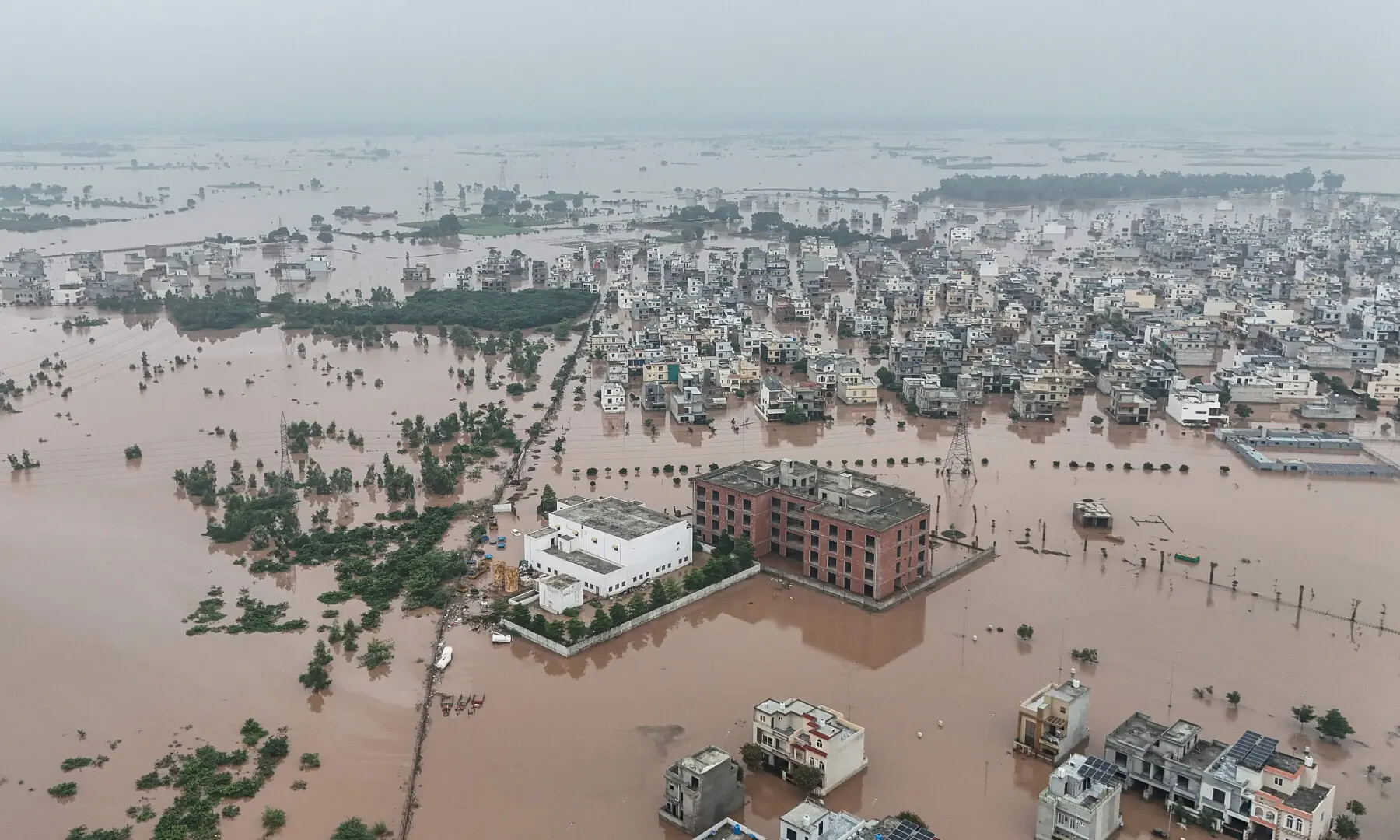  This aerial view shows partially submerged residential buildings following the overflowing of the Ravi River in Lahore on August 30, 2025. &mdash; AFP 
