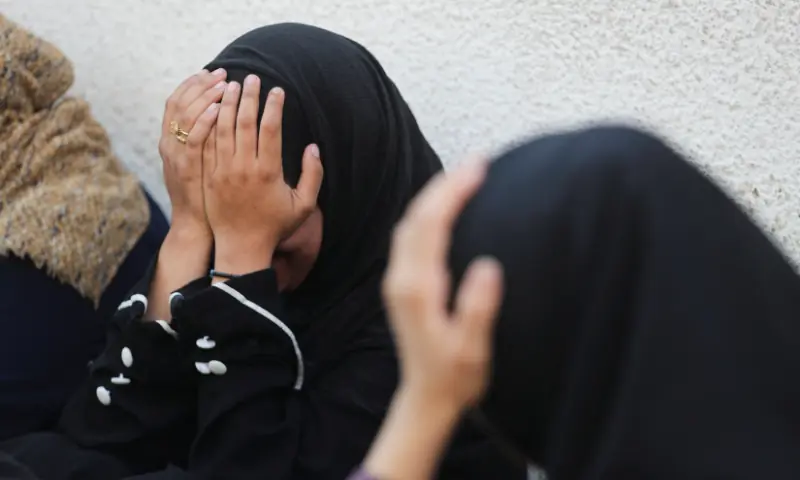 Mourners react during the funeral of Palestinians who were killed by Israeli fire while trying to receive aid and another killed in a strike on Friday, according to medics, at Al-Shifa Hospital in Gaza City, on August 30. &mdash; Reuters