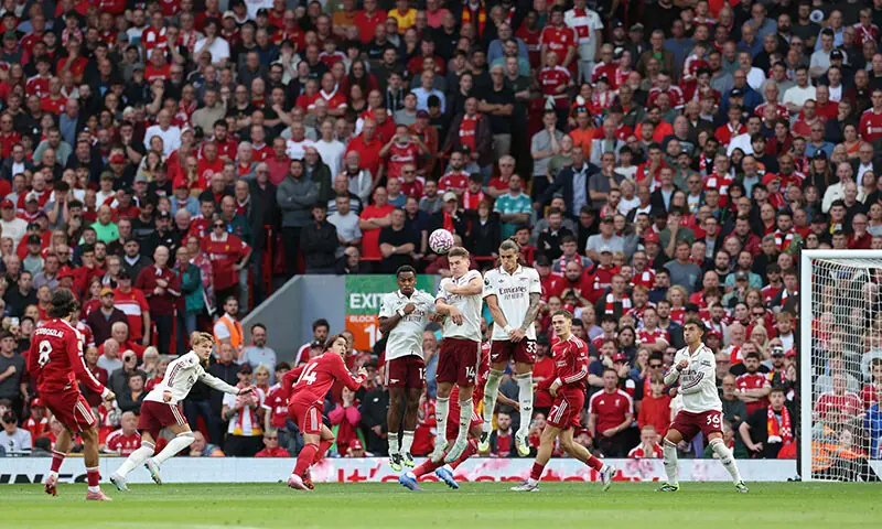 Liverpool&rsquo;s Hungarian midfielder Dominik Szoboszlai (L) strikes the ball over the wall from a free kick to score the opening goal during the English Premier League football match against Arsenal at Anfield in Liverpool, northwest England on August 31. &mdash; AFP