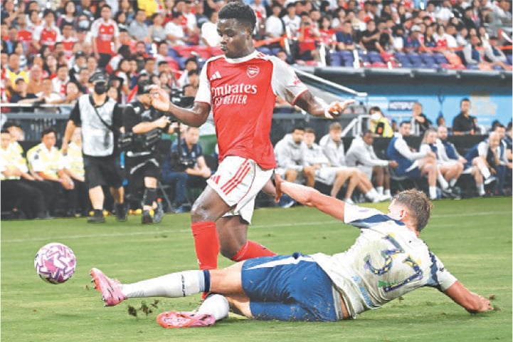 HONG KONG: Arsenal’s Bukayo Saka (top) vies for the ball with Micky van de Ven of Tottenham Hotspur during their friendly match at the Kai Tak Stadium on Thursday.—AFP