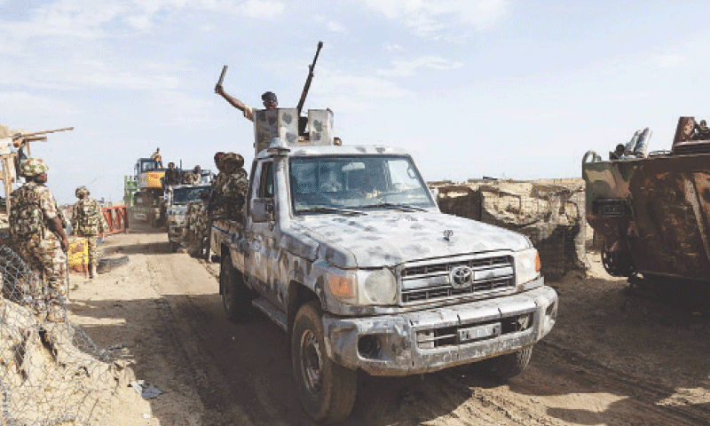 A CONTINGENT of the Multinational Joint Task Force passes through a checkpoint at the entrance to Monguno, a garrison town in Nigeria&rsquo;s Borno state.&mdash;AFP