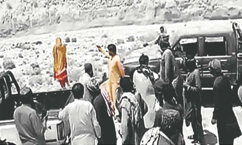 Screengrab from the viral video, showing the victim having her back towards her brother, who has a gun pointed at her