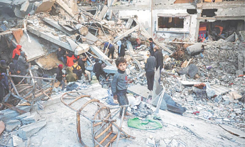 People in Gaza comb the rubble of a building destroyed in an Israeli strike on the Bureij camp for Palestinian refugees | AFP