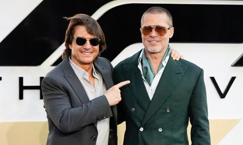 Tom Cruise points at Brad Pitt during a photo-op during the F1 premiere in London | Neil Hall/EPA