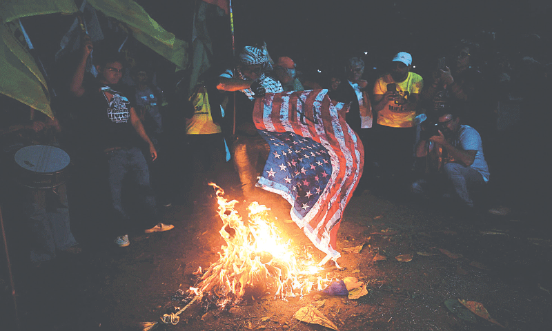 Demonstrators burn a US flag during a protest in defence of national sovereignty after trade tariffs and sanctions were imposed by the US government on Brazil, near the US consulate in Rio de Janeiro, Brazil. Trump&rsquo;s Brazil tariff is among the highest imposed on US trading partners, and unlike with other countries, the measures have been framed in openly political terms, sweeping aside centuries-old trade ties and a surplus that Brasilia put at $284 million last year.&mdash;AFP