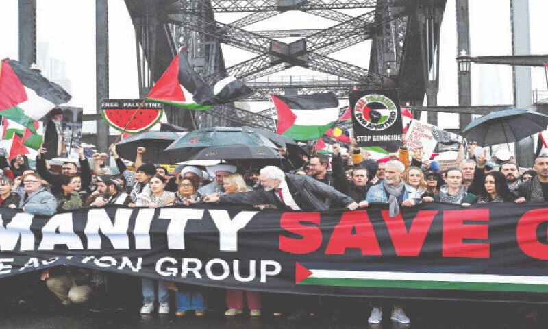 DEMONSTRATORS, including WikiLeaks founder Julian Assange, cross the Sydney Harbour Bridge during a pro-Palestinian rally against Israel&rsquo;s military actions and the aid blockade in the Gaza Strip.&mdash;AFP