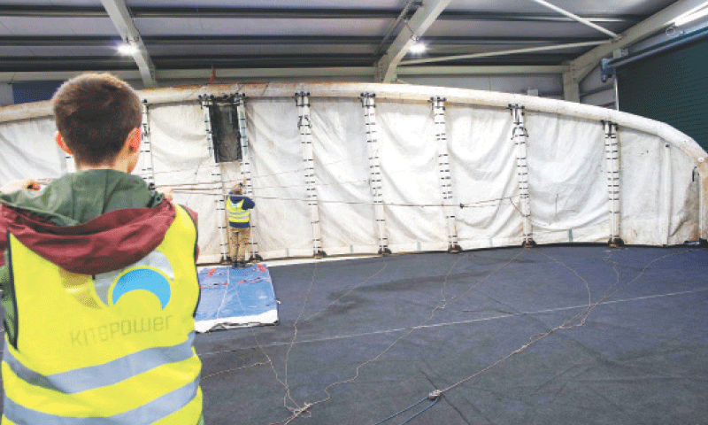 Two Kitepower employees prepare to launch a kite in Bangor Erris, Ireland.&mdash;AFP