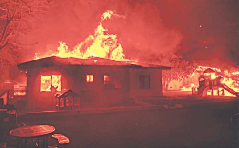 Flames engulf homes in Los Angeles as wildfires in January fuel record insured losses, with damages from the blazes alone estimated at $40bn — the costliest wildfire event in history, according to Swiss Re.—AFP