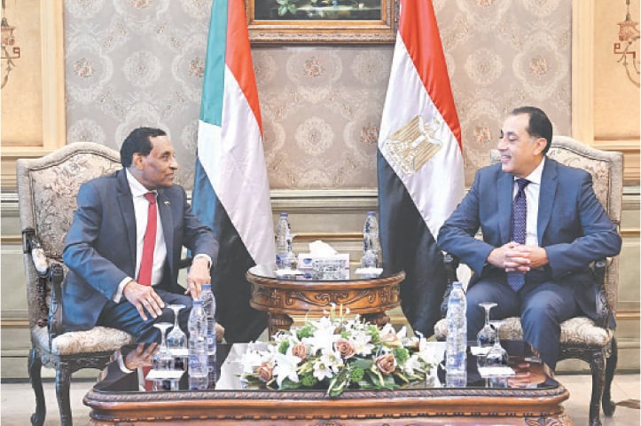 Egypt&rsquo;s Prime Minister Mostafa Madbouly (right) meets his counterpart from Sudan, Kamil Idris, upon his arrival. &mdash; AFP