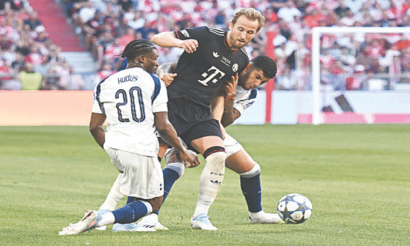 MUNICH: Bayern Munich&rsquo;s Harry Kane (C) vies for the ball with Tottenham Hotspur&rsquo;s Mohammed Kudus (L) and Cristian Romero during their pre-season friendly at the Allianz Arena on Thursday. Kane scored his first goal against his former side as Bayern romped past Tottenham 4-0.&mdash;Reuters