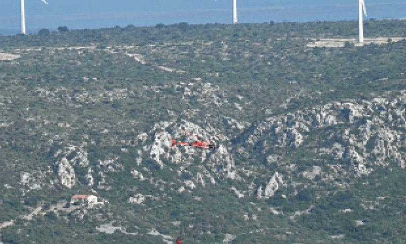 A HELICOPTER drops water near a village in southern France. &mdash;AFP