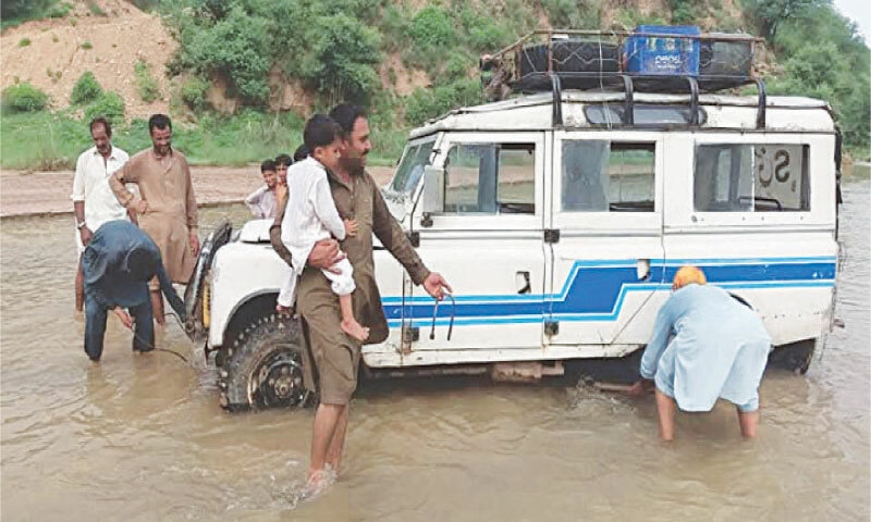 Commuters, including children, are being offloaded after a van got stuck in Banhaa River. &mdash; Dawn