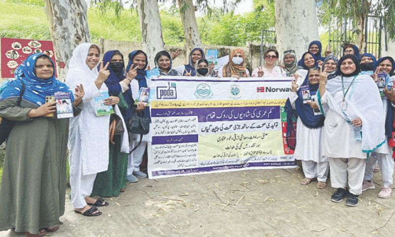 Participants of a workshop hold a banner calling for an end to early marriages in Rawalpindi on Monday. &mdash; White Star