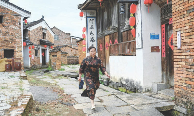 A woman walks on a street at Goulan Yao Village in Jiangyong county, in southern China&rsquo;s Hunan province.&mdash;AFP