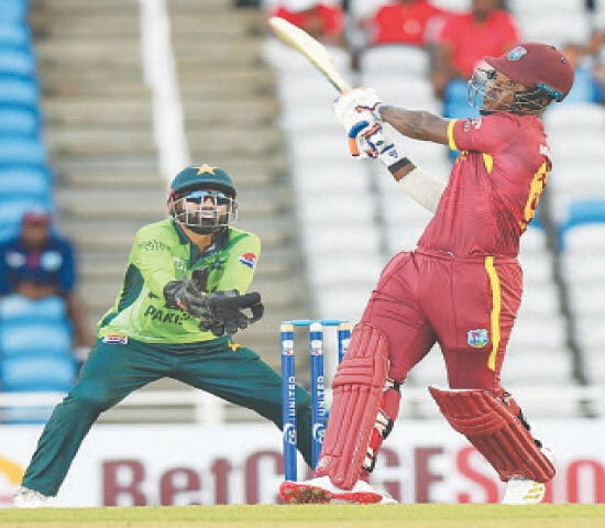 WEST INDIES batter Sherfane Rutherford smashes a six as Pakistan captain Mohammad Rizwan looks on during the second One-day International at the Brian Lara Cricket Academy.&mdash;AFP