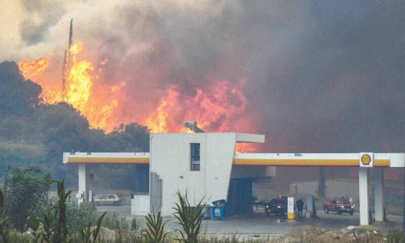 A WILDFIRE burns near a petrol station in Patras, western Greece.&mdash;AFP