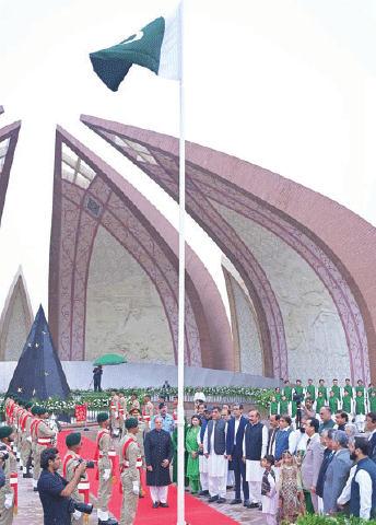 Prime Minister Shehbaz Sharif stands in respect after hoisting National Flag at Pakistan Monument in Islamabad on Thursday. &mdash; White Star