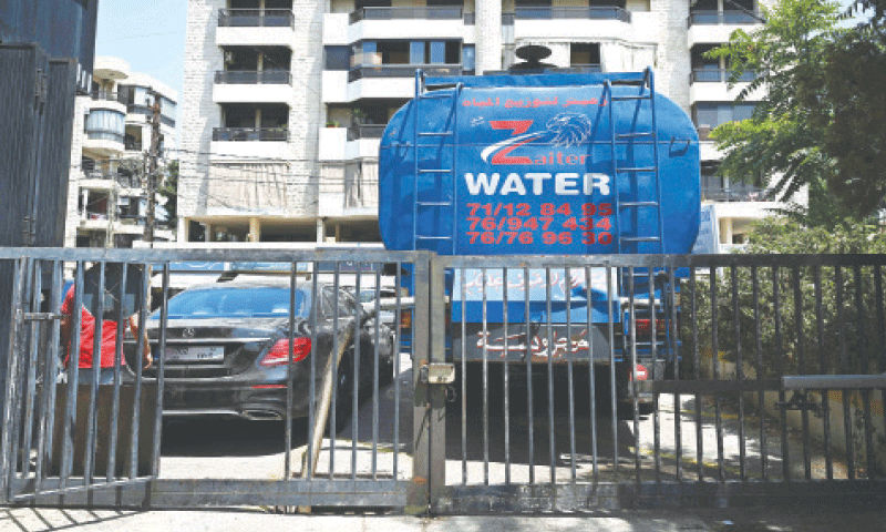 A tanker supplies water on the outskirts of Lebanon’s capital on Thursday.—AFP A tanker supplies water on the outskirts of Lebanon’s capital on Thursday.—AFP