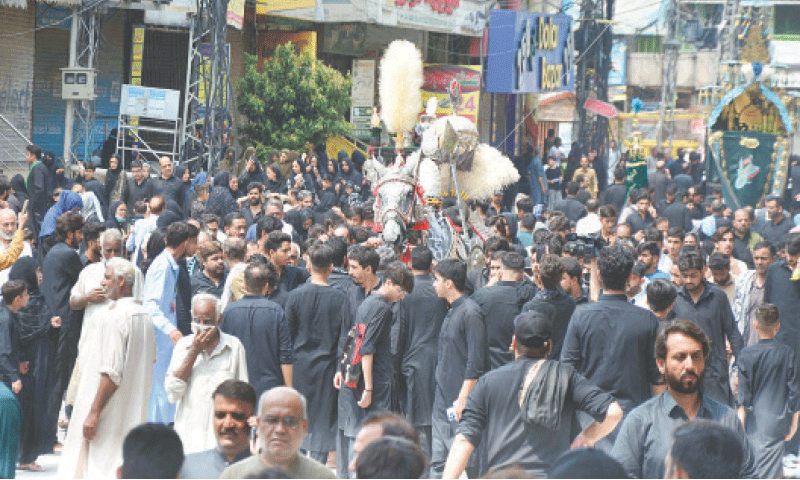 People participate in a mourning procession on the occasion of Imam Hussain’s Chehlum in Rawalpindi on Friday. — Online People participate in a mourning procession on the occasion of Imam Hussain’s Chehlum in Rawalpindi on Friday. — Online
