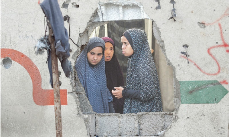 Palestinians inspect the site of a Friday Israeli strike on a school in Gaza City that was sheltering displaced people.&mdash;Reuters