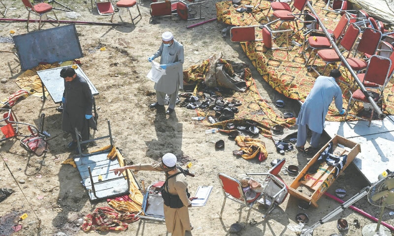  Police officials examine the site of a suicide bombing carried out by the Islamic State Khorasan Province (ISKP) at a Jamiat Ulema-i-Islam-Fazl (JUI-F) rally in Bajaur district on July 31, 2023: frustrated by a surge in terrorist attacks, Pakistan has adopted a mix of hard and soft power tactics to pressure the Taliban administration in Kabul | AFP 