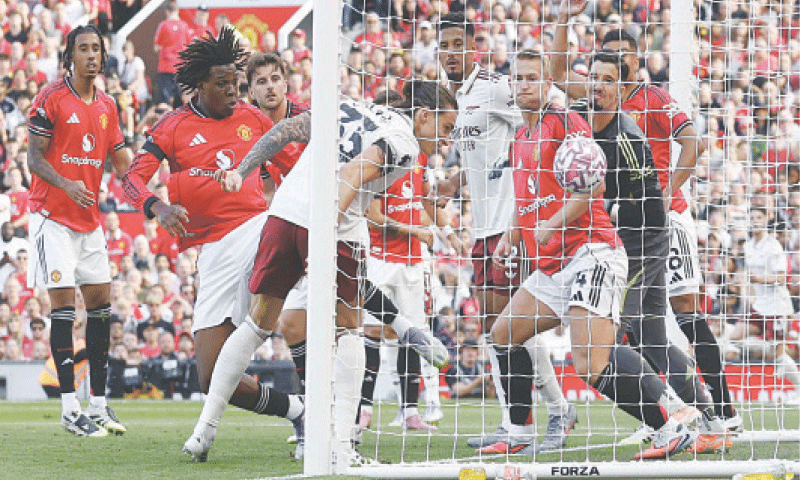 MANCHESTER: Arsenal’s Riccardo Calafiori (front) heads to score during the Premier League match against Manchester United at Old Trafford on Sunday.—Reuters MANCHESTER: Arsenal’s Riccardo Calafiori (front) heads to score during the Premier League match against Manchester United at Old Trafford on Sunday.—Reuters