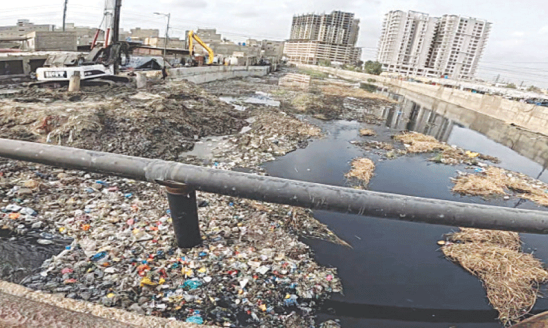 Heaps of garbage dumped in the Mehmoodabad nullah hinder sewage flow.&mdash;Fahim Siddiqi / White Star