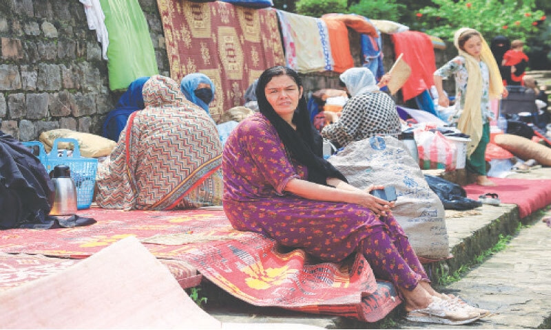 Tayyaba sits with other Afghans in Argentina Park.&mdash;Reuters