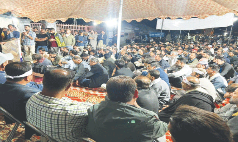 Traders stage protest sit-in at KKH near Khunjerab Pass on Thursday. &mdash; Dawn