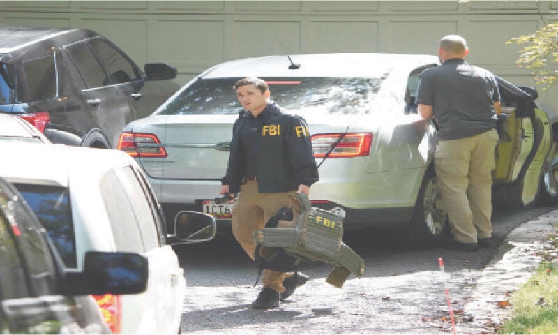 INVESTIGATORS work outside the home of John Bolton, a former national security adviser, in Bethesda, Maryland. &mdash; AFP