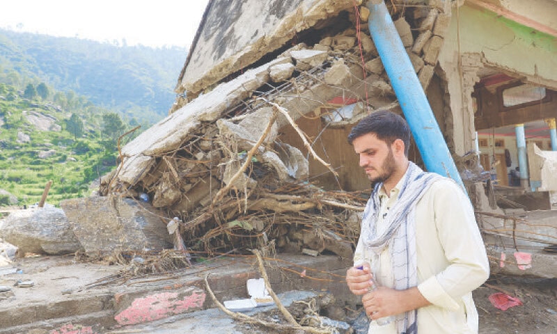 Noor Muhammad, who lost 24 family members and relatives, stands by the rubble of his 36-room house in Buner&rsquo;s Qadir Nagar village.&mdash;Reuters