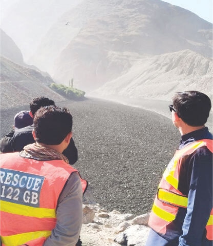  GHIZER: Rescue 1122 personnel monitor the glacial lake outburst flood that blocked the river near Tildas village in the Gupis valley.—Dawn 