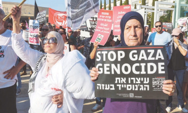 Arab-Israeli and Israeli left-wing activists hold placards and photos of malnurished children during a protest in Tel Aviv.—AFP Arab-Israeli and Israeli left-wing activists hold placards and photos of malnurished children during a protest in Tel Aviv.—AFP