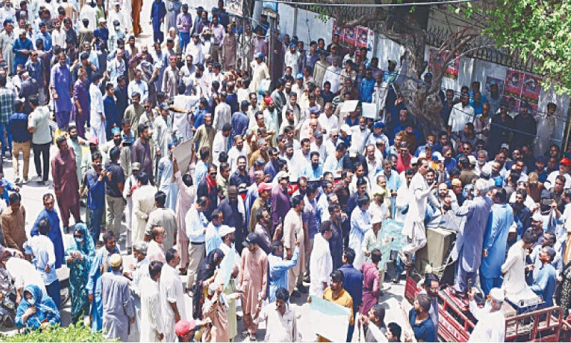 PROTESTING government employees hold a demonstration outside Hyderabad Press Club.&mdash;Dawn