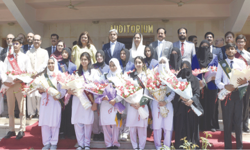 Minister of State for Education Wajiha Qamar, FBISE Chairman Prof Dr Ikram Ali Malik and others pose for a group photograph with position holders at the board’s auditorium in Islamabad on Tuesday. — Photo by Tanveer Shahzad