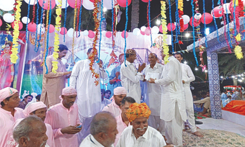 members of Sukkur&rsquo;s Hindu community greet each other at the festival.&mdash;Dawn
