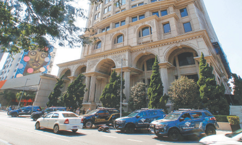 POLICE vehicles are parked outside a building at Sao Paulo’s financial centre.—AFP