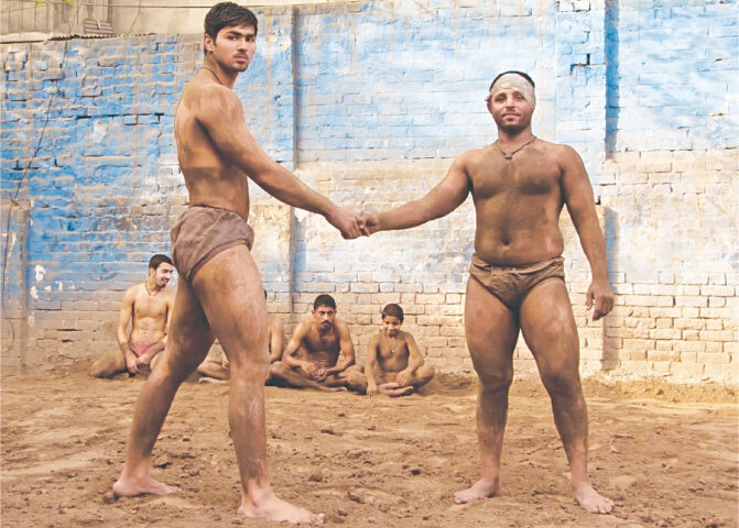 Local wrestlers do the pre-bout mandatory handshake at a pit in Lahore’s Walled City in 2012 | Photos by the writer