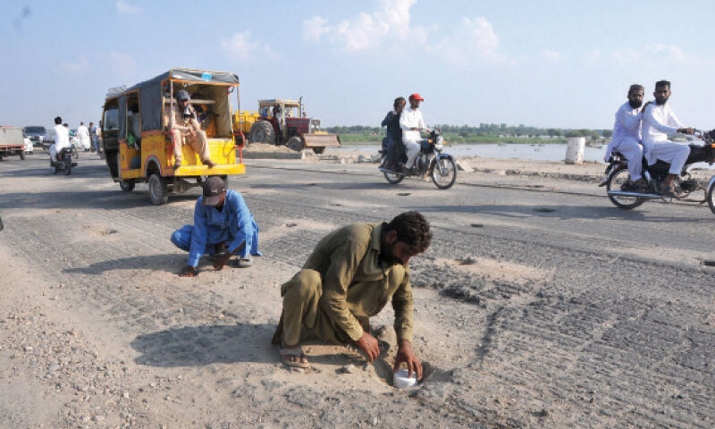 MULTAN: Workers of the local administration mark points to install dynamite near Head Muhammadwala breaching site as a precautionary measure to divert Chenab flood. &mdash; APP
