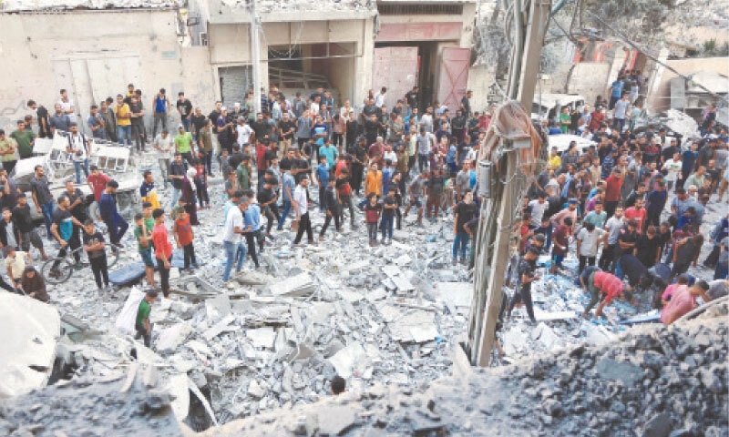 Palestinians gather to look for survivors in Al-Rimal neighbourhood of Gaza City after an Israeli strike.&mdash;AFP