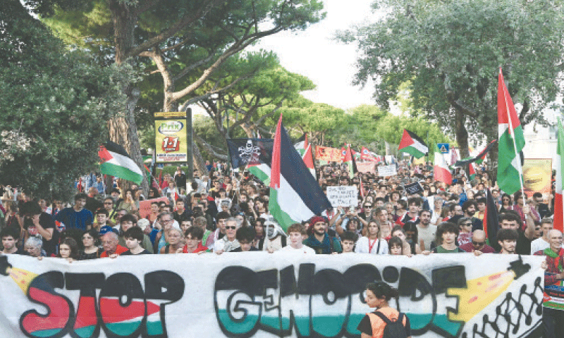 DEMONSTRATORS march behind a banner reading &lsquo;Stop Genocide&rsquo; during the Venice International Film Festival.&mdash;AFP