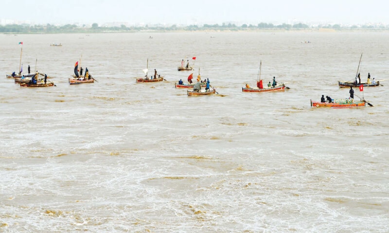Several boats carrying fishermen are seen downstream at Kotri barrage on August 30, which has remained in low floods for the past several days. &mdash; Umair Ali