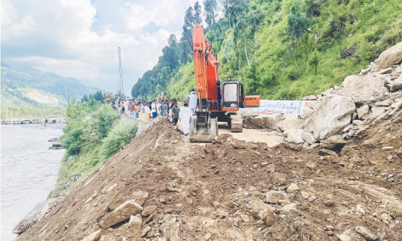 Heavy machinery being used to clear the debris after a landslide blocked a section of MNJ Road in Hassa area near Balakot, Mansehra . &mdash; Photo by Nisar Ahmad Khan