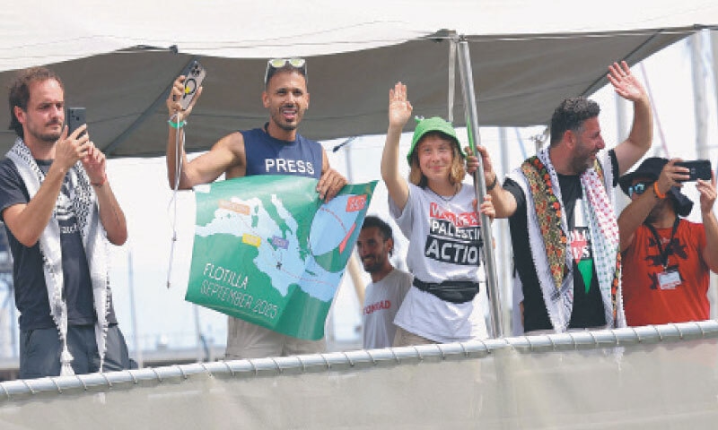 Swedish climate campaigner Greta Thunberg (centre) and other rights activists wave as their boat leaves the port of Barcelona.&mdash;AFP