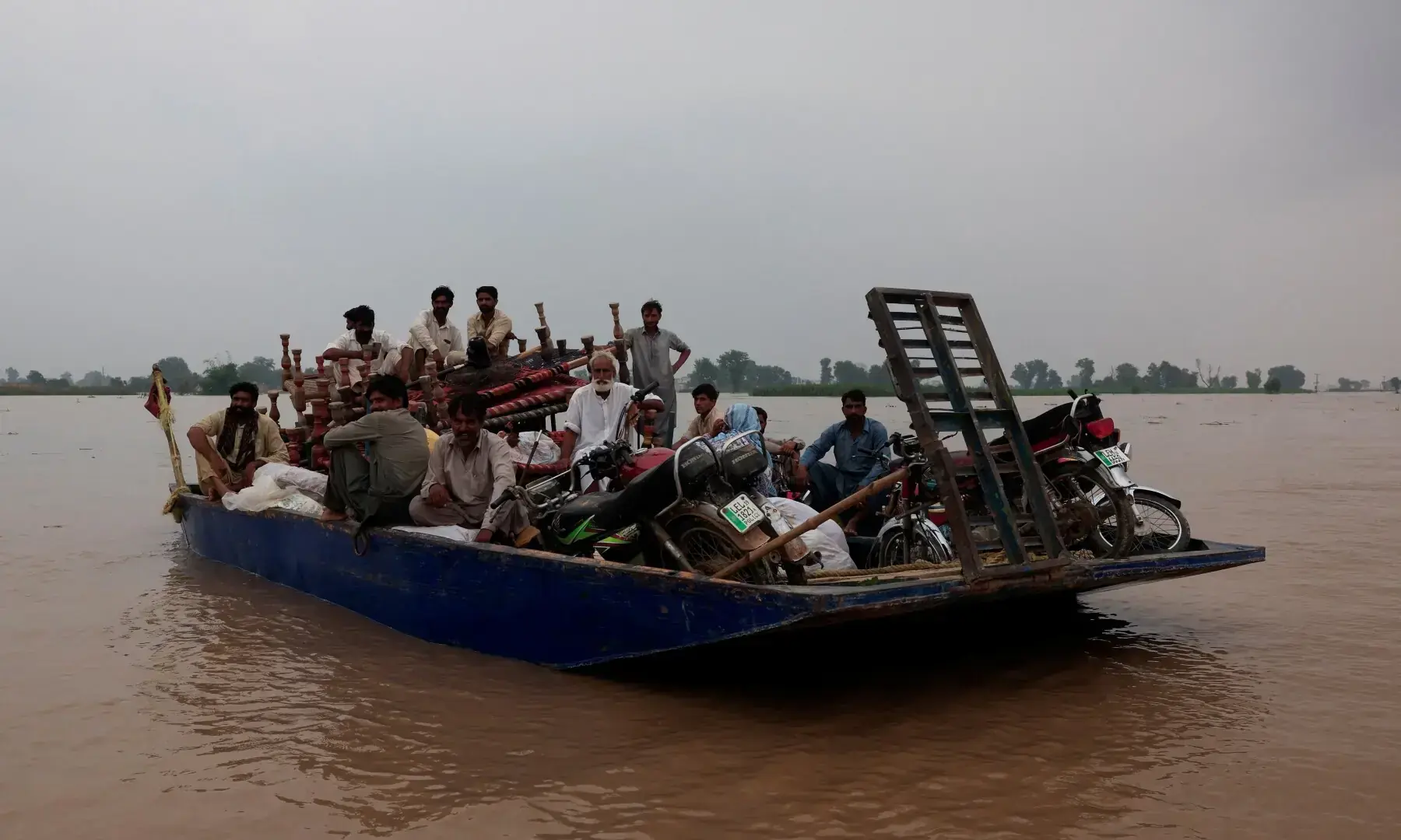 Residents travel with their belongings on a boat as they head towards a higher ground, following the monsoon rains and rising water level of the Sutlej River, in Chanda Singh Wala village near the Pakistan-India border in Kasur district, Aug 29. — Reuters Residents travel with their belongings on a boat as they head towards a higher ground, following the monsoon rains and rising water level of the Sutlej River, in Chanda Singh Wala village near the Pakistan-India border in Kasur district, Aug 29. — Reuters