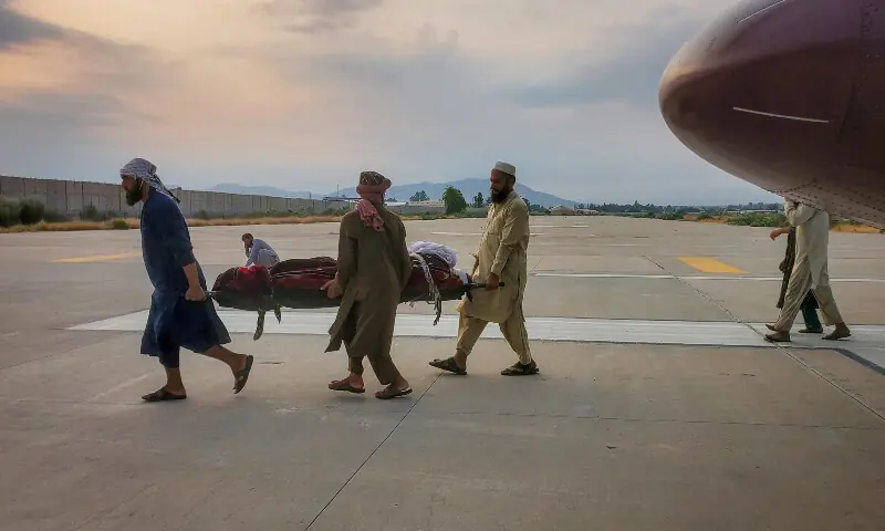 People carry an earthquake victim on a stretcher to an ambulance at an airport in Jalalabad, Afghanistan, on Sept 1. &mdash; Reuters