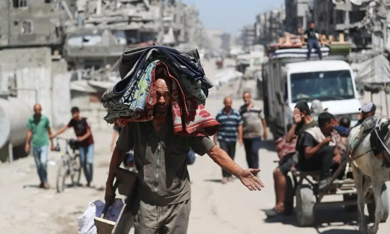 A displaced Palestinian carries belongings, as he flees amid an Israeli military operation, in Gaza City, September 1. &mdash; Reuters