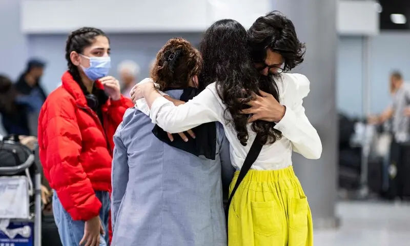 Flight passengers of Afghan families who fled the Taliban are welcomed at the airport after arriving in Hannover-Langenhagen, northwestern Germany, Sept 1. &mdash; AFP