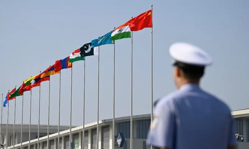 Flags flutter outside the Tianjin Meijiang Convention and Exhibition Centre during the Shanghai Cooperation Organisation (SCO) Summit in Tianjin on September 1. &mdash; AFP
